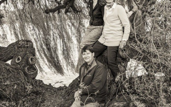 Portrait photograph of brother sisters in tree