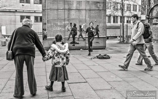 juggler performing against mirrored wall london south bank