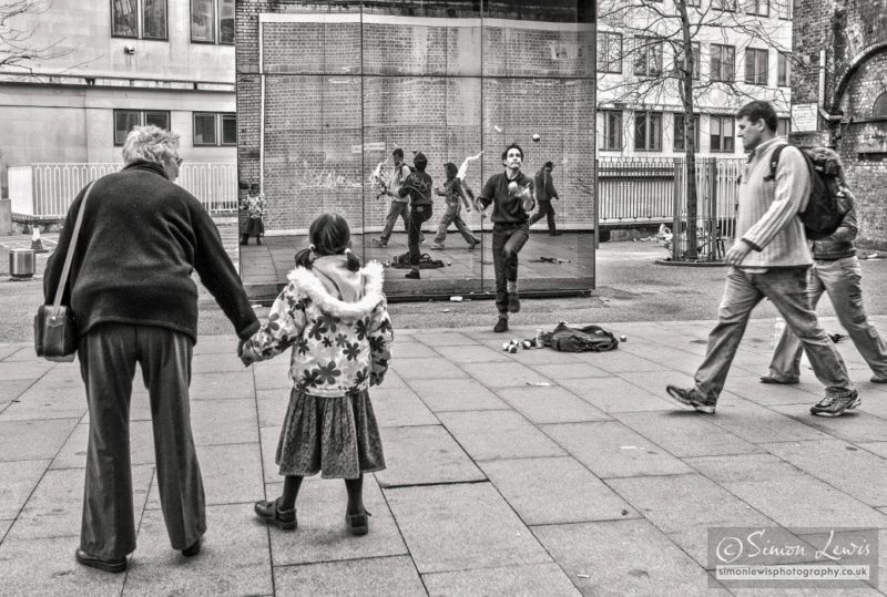 juggler performing against mirrored wall london south bank