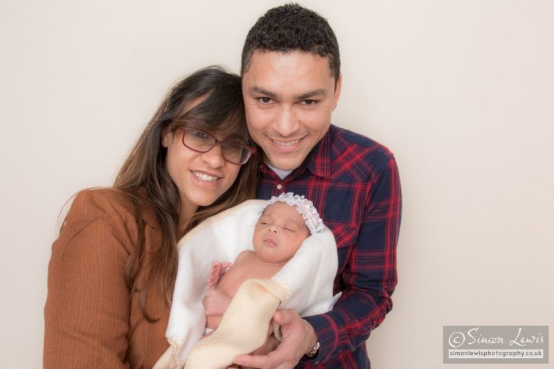 Portrait of proud parents with baby