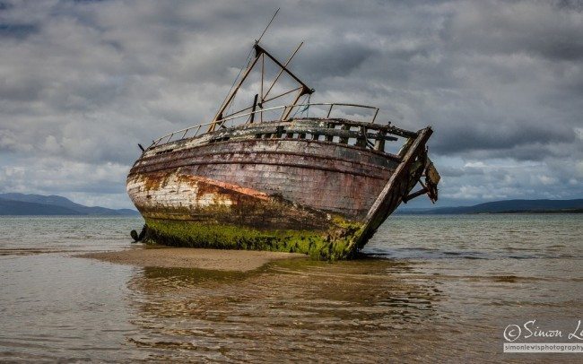 beached rotten wooden wreck of fishing boat Isle of Bute