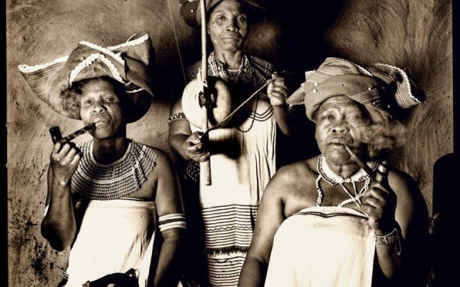 trio from women ensamble smoking traditional pipes