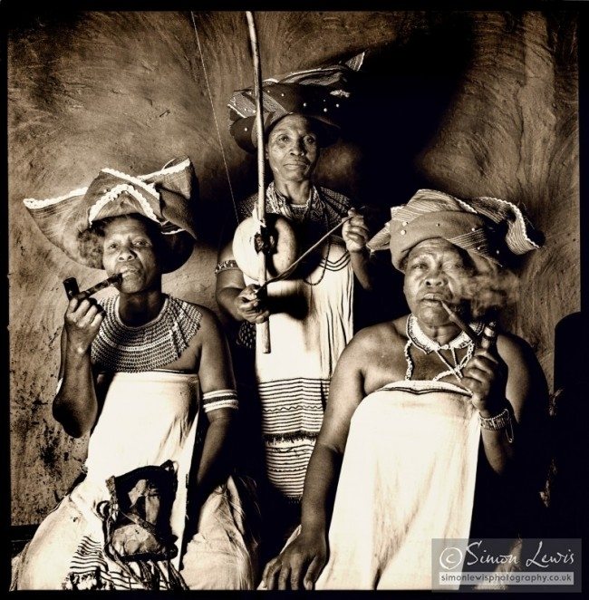 trio from women ensamble smoking traditional pipes