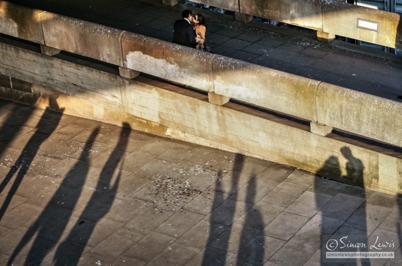 London south bank in later afternoon shadows couple kissing