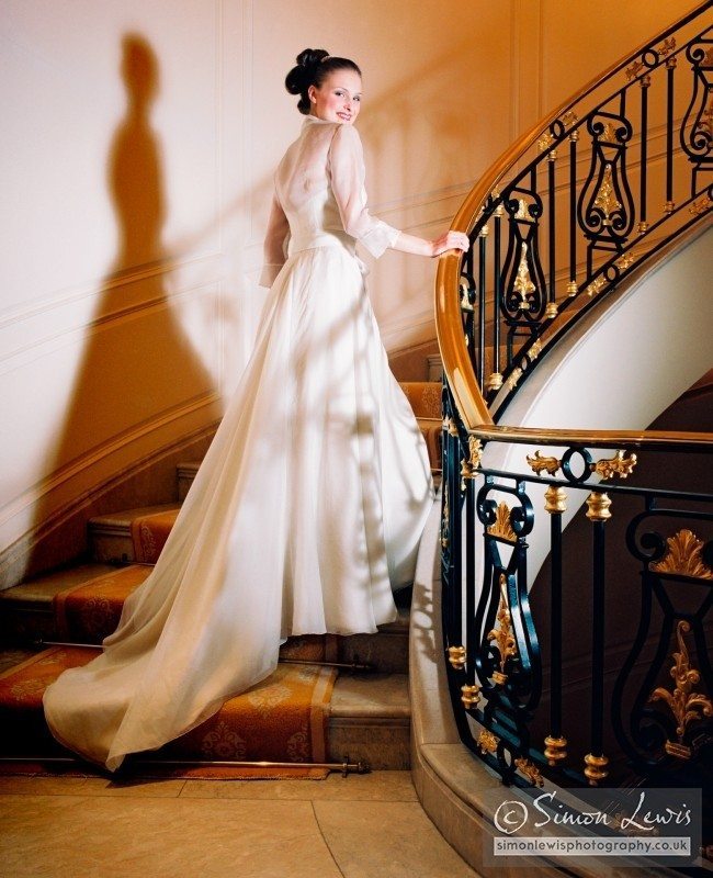 beautiful smiling bride in white dress on staircase